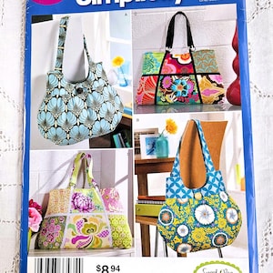 May include: Simplicity sewing pattern for Sweet Pea Totes. The pattern features tote bag designs with floral and geometric patterns. The cover is blue and pink with the text "Simplicity" and "Sweet Pea Totes".