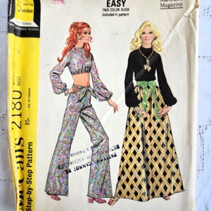 May include: Vintage McCall's sewing pattern for misses' skirt, trousers, and blouse in two lengths. The pattern features illustrations of the designs, including a crop top and flared trousers. The packaging is yellow and cream-coloured.