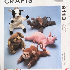 May include: A sewing pattern for five plush toys: a cow, an elephant, a dog, a pig, and a monkey. The pattern is called "Bambini" and is from McCall's Crafts.