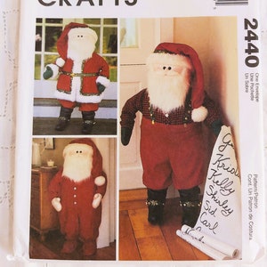 May include: McCall's Crafts sewing pattern for making a Santa Claus doll. The pattern includes three different designs for the doll, each with a different outfit. The pattern is labelled "2440".