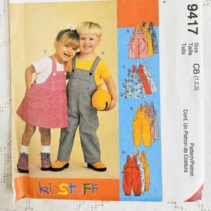 May include: An Easy McCall's 9417 sewing pattern envelope for children's clothing. The front features illustrations of children wearing overalls and a jumper, with text including "Easy McCall's," "9417," "Size CB (1,2,3)," and "KidStuff."