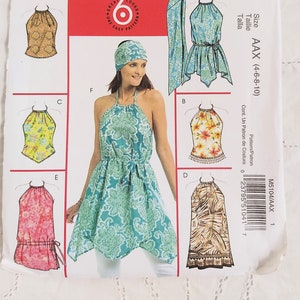 May include: A sewing pattern for a halter top and dress. The pattern includes five different styles, with a variety of colours and patterns. The pattern is for sizes 4-6-8-10. The pattern is called McCall's M5104.