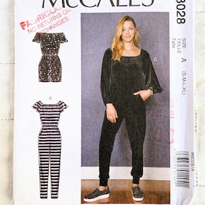 May include: A sewing pattern for two jumpsuit styles. The first jumpsuit is a black and white striped off-the-shoulder style. The second jumpsuit is a black velvet style with a square neckline and long sleeves. The pattern is for sizes S-M-L-XL. The pattern is from McCall's and the pattern number is M8028.
