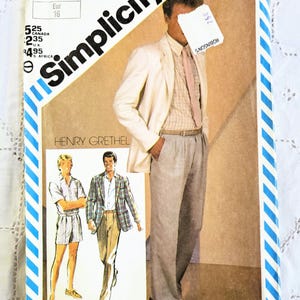 May include: A vintage Simplicity sewing pattern showing a man in a cream blazer, light pink tie, and grey trousers. The pattern includes illustrations of men's clothing designs. The package has a blue and white striped border.