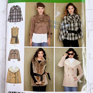 May include: Simplicity sewing pattern number 2285 for sizes UK 12, 14, 16, 18, 20, EUR 42-50, FR 44-52. The pattern includes four different styles of jackets and vests: a plaid cape, a brown cropped jacket, a leopard print vest, and a tan double-breasted jacket.