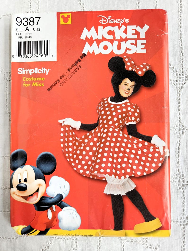 May include: A Simplicity sewing pattern for a Minnie Mouse costume. The cover features a red and white polka dot dress and Mickey Mouse. The pattern is for sizes 8-18, with European sizes 34-44 and French sizes 36-46.