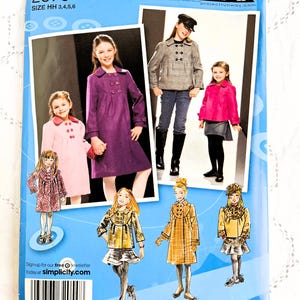 May include: Simplicity sewing pattern number 2876 for girls' coats. The pattern includes six different styles of coats, including a purple coat, a pink coat, a plaid coat, a black and white coat, and a brown coat. The pattern is inspired by Project Runway.
