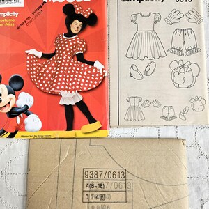 May include: A selection of vintage sewing patterns, including a Disney's Mickey Mouse costume and a Simplicity pattern. The Mickey Mouse pattern cover is red, showcasing a person in the costume. The Simplicity pattern features illustrations of a dress, shorts, gloves, and shoes.