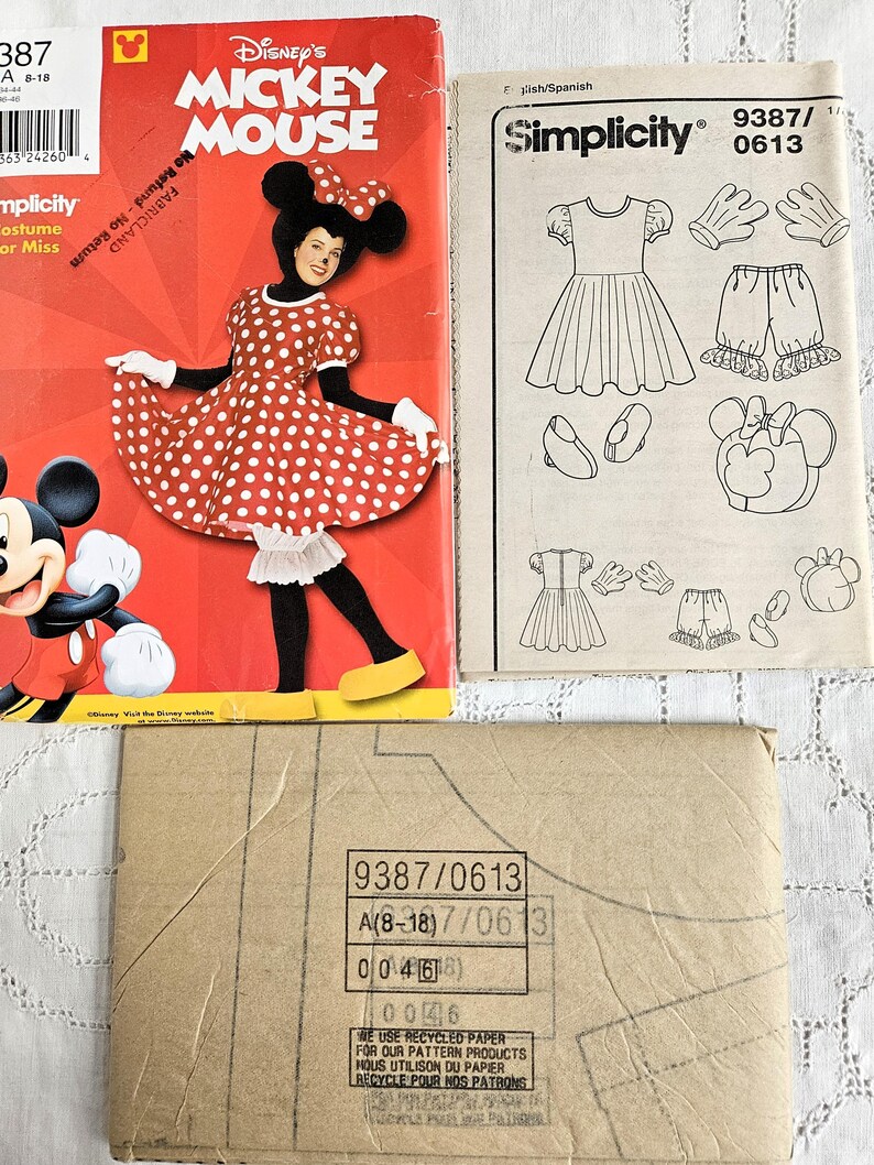 May include: A selection of vintage sewing patterns, including a Disney's Mickey Mouse costume and a Simplicity pattern. The Mickey Mouse pattern cover is red, showcasing a person in the costume. The Simplicity pattern features illustrations of a dress, shorts, gloves, and shoes.