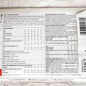 May include: Simplicity pattern 9387 for a Misses' Minnie Mouse costume. Includes pattern pieces for a dress, bow, gloves, and shoes. The pattern details body measurements and fabric requirements. The package is white and red.