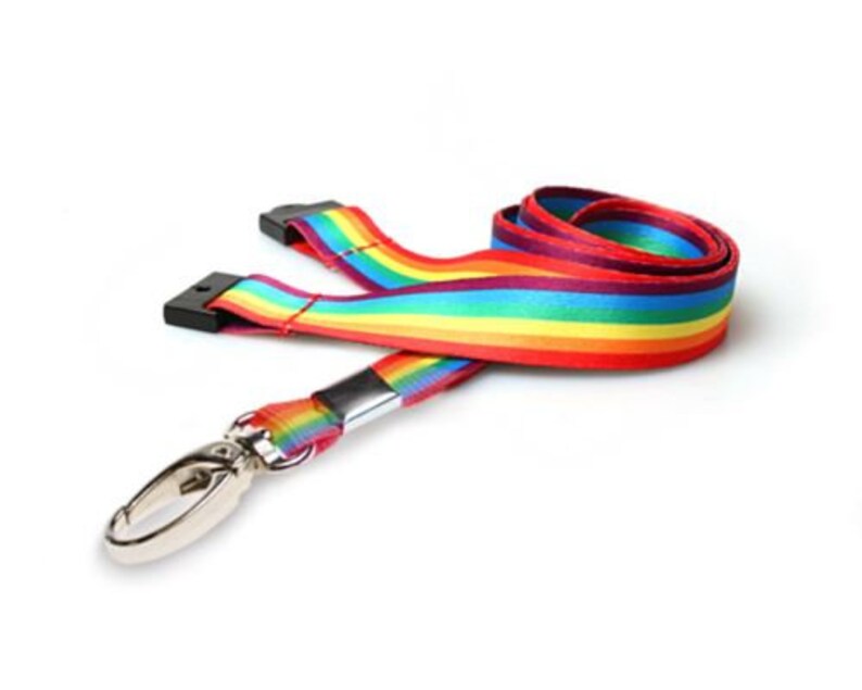 May include: A rainbow lanyard with a silver swivel hook. The lanyard is made of a woven fabric with red, orange, yellow, green, blue, indigo, and violet stripes.
