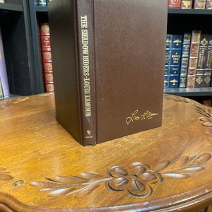 Sold at Auction: LOUIS L'AMOUR LEATHERETTE WESTERN HARDCOVERS