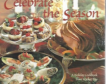 May include: A cookbook cover with the title "Celebrate the Season" in red script. The image features a holiday spread with a glazed ham, appetizers, and desserts on decorative plates, with lit candles in the background.