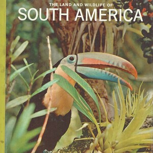 May include: A colorful toucan with a large orange, blue, and black beak is perched on a branch in a lush green jungle setting. The book cover features the text "LIFE NATURE LIBRARY THE LAND AND WILDLIFE OF SOUTH AMERICA".