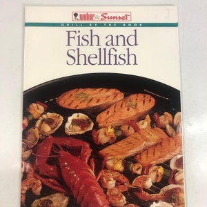 May include: A cookbook cover featuring a Weber & Sunset Grill by the Book logo. The cover shows a variety of grilled seafood, including salmon, lobster, shrimp, and oysters. The text on the cover reads "Fish and Shellfish".