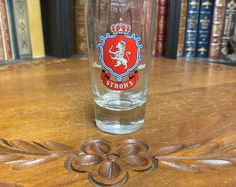 May include: A clear glass beer stein with a red and blue crest featuring a lion and the text "Since 1850 Stroh's".