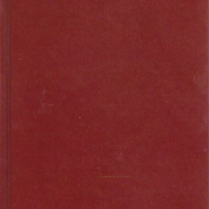 May include: A red book with gold lettering on the spine and front cover. The title of the book is "Kabloona" by Gontran de Poncins.