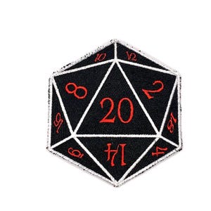 May include: Black and white embroidered patch in the shape of a twenty-sided die. The numbers are red, with the number 20 prominently displayed. The patch is designed for role-playing games.