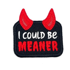 May include: Embroidered patch with a black background, red devil horns, and the text "I COULD BE MEANER" in white and red. The patch has a rectangular shape with rounded corners.