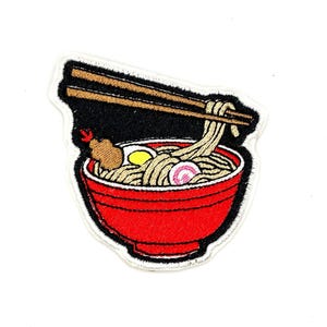 May include: Embroidered iron-on patch featuring a red bowl of ramen noodles with chopsticks. The bowl contains noodles, an egg, a piece of meat, and a pink swirl.