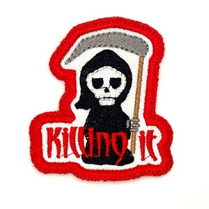 May include: Red embroidered patch with a cartoon Grim Reaper holding a scythe and the text "Killing it".