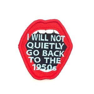 May include: Red embroidered patch with a large open mouth and the text "I WILL NOT QUIETLY GO BACK TO THE 1950s".
