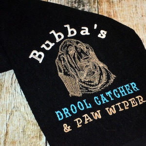 May include: Black towel with embroidered text "Bubba's Drool Catcher & Paw Wiper" and an embroidered image of a brown and white Bloodhound dog.
