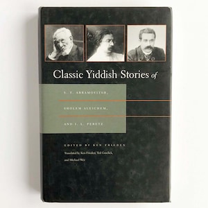 May include: A hardcover book titled "Classic Yiddish Stories of" featuring portraits of three men at the top. The book's cover is dark with a green and white section containing the authors' names and the editor's name.