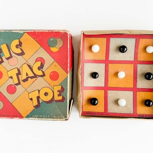 May include: Vintage Tic Tac Toe game in a colorful box. The box is red, green, and yellow with the game title in large letters. The game board is inside, with a grid of squares and black and white game pieces. Made in the USA.