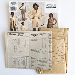May include: Vogue Wardrobe sewing pattern packet with images of a woman wearing a coat, top, and pants. The packet includes pattern pieces and instructions. The pattern number is V2857.