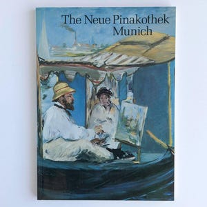 May include: A book cover featuring an impressionist painting of two people in a boat. The text "The Neue Pinakothek Munich" is at the top. The painting is in shades of blue, white, and yellow.