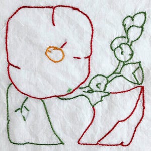 May include: Embroidered floral design on white fabric. The design features a large, stylized flower with a red outline and an orange centre. Green leaves and stems are also embroidered, creating a simple botanical illustration.