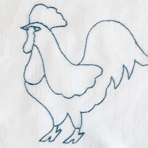 May include: A white fabric square featuring a blue embroidered outline of a rooster. The rooster is depicted in profile, with a detailed comb, wattle, and tail feathers. The embroidery is done with a continuous line.