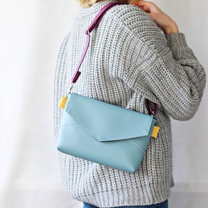 Blue envelope bag. shoulder bag. minimalistic bag for women. yellow and purple bag. smallshoulder bag. leather mini bag. grey sweater and blue bag.