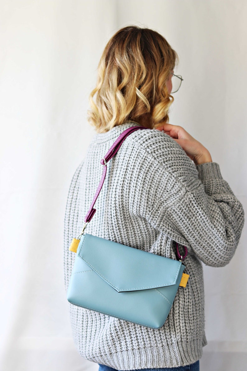 Blue envelope bag. shoulder bag. minimalistic bag for women. yellow and purple bag. smallshoulder bag. leather mini bag. grey sweater and blue bag.