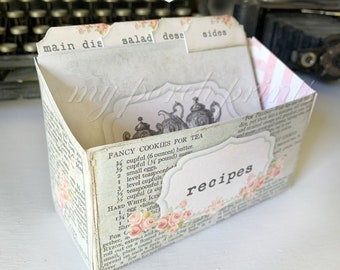 May include: A white printable recipe box with a shabby chic design. The box has four dividers labeled "main dish", "salad", "dess", and "sides". The box is decorated with a floral pattern and a vintage-style teapot illustration. The text "recipes" is printed on the front of the box.