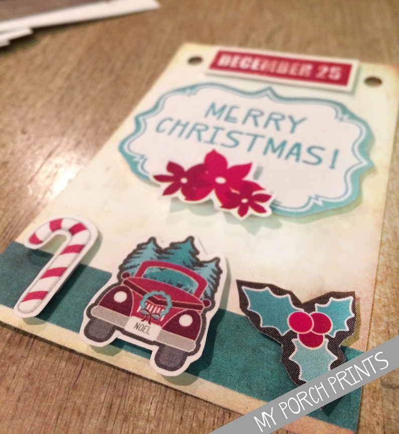 May include: A Christmas card with a red truck carrying a Christmas tree, a candy cane, a holly sprig, and a red poinsettia. The card says "Merry Christmas!" and "December 25". It also says "My Porch Prints" at the bottom.