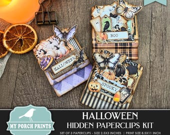 May include: A set of three printable Halloween paperclip cards. Each card features a different Halloween theme with images of pumpkins, bats, and butterflies. The cards are designed to be printed and cut out, then used as paperclips. The cards are 2.5 inches by 3 inches and are designed to be printed on 8.5 inch by 11 inch paper.