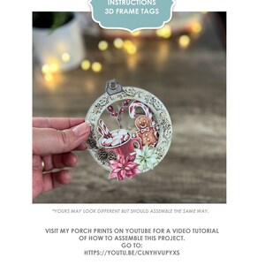 May include: A 3D frame tag in the shape of a Christmas ornament with a gingerbread man, candy canes, and a mug of hot chocolate. The tag is made of paper and has a vintage look. The text on the tag reads "My Porch Prints Instructions 3D Frame Tags".