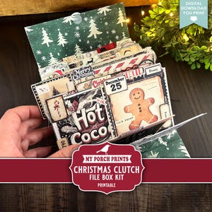 May include: A Christmas-themed file box kit with a green and white tree pattern. The kit includes various cards with festive designs, such as a gingerbread man, candy cane, and the text "Hot Coco". The text "Merry Christmas" is also visible.