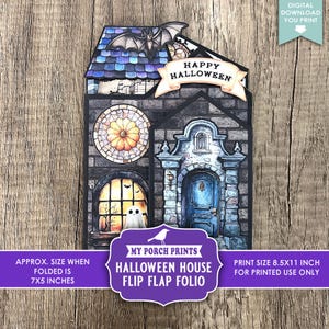 May include: A Halloween-themed flip-flap folio featuring a haunted house design. The house has a blue door, stained-glass window, and a bat on the roof. The folded size is approximately 7x5 inches.