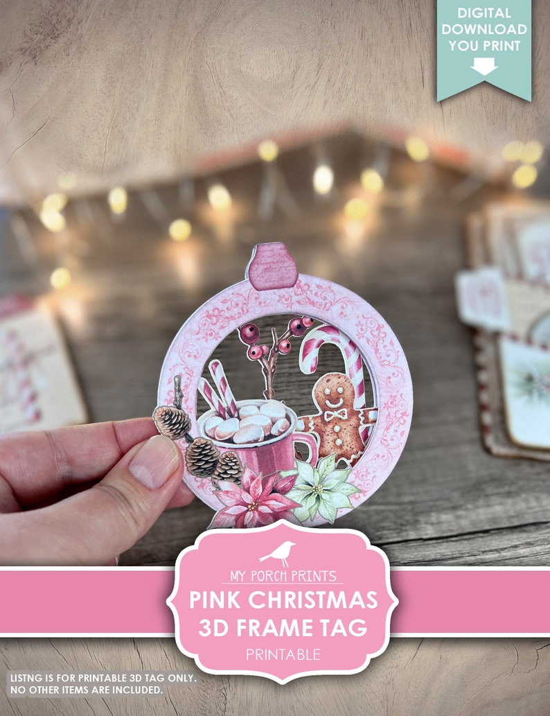 Puede incluir: Etiqueta de marco 3D de Navidad rosa imprimible, con un hombre de jengibre, bastones de caramelo, una taza de chocolate caliente con malvaviscos, pi&ntilde;as y poinsettias. La etiqueta est&aacute; dise&ntilde;ada para ser impresa y ensamblada en un marco 3D.