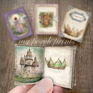May include: A small, open book with a watercolor illustration of a fairytale castle on the left page and a green fairy crown on the right page. The book is open to show the pages and is being held by a hand.