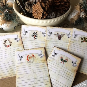 May include: Set of six vintage-style recipe cards with Christmas themes. Each card features a different festive illustration, including a wreath, holly, pine cones, Santa Claus, and candy canes. The cards have blank lines for writing down ingredients and directions.