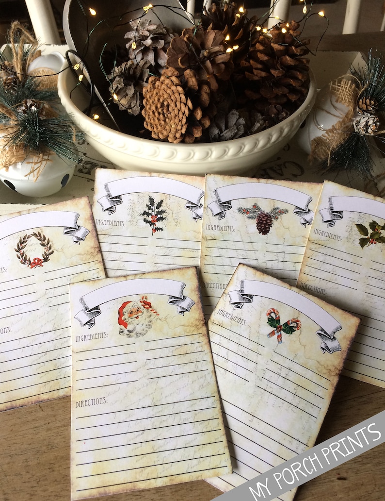 May include: Set of six vintage-style recipe cards with Christmas themes. Each card features a different festive illustration, including a wreath, holly, pine cones, Santa Claus, and candy canes. The cards have blank lines for writing down ingredients and directions.