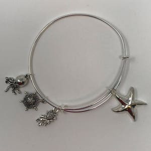 Starfish - Silver Toned Adjustable Bangle Bracelet With Ocean Themed Charms Symbolizes Movement and Flow in the Universe
