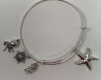 Starfish - Pulsera ajustable tonada de plata con encantos temáticos del océano simboliza el movimiento y el flujo en el universo