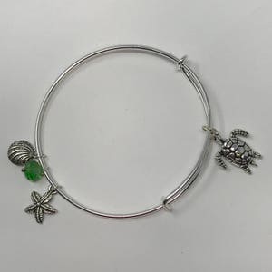 Sea Turtle - Silver Toned Adjustable Bangle Bracelet With Ocean Themed Charms Symbolizes Good Luck, Endurance and Long Life