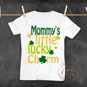 May include: White t-shirt with the text "Mommy's little lucky charm" in green, yellow, and gold lettering. The text is surrounded by shamrock designs.