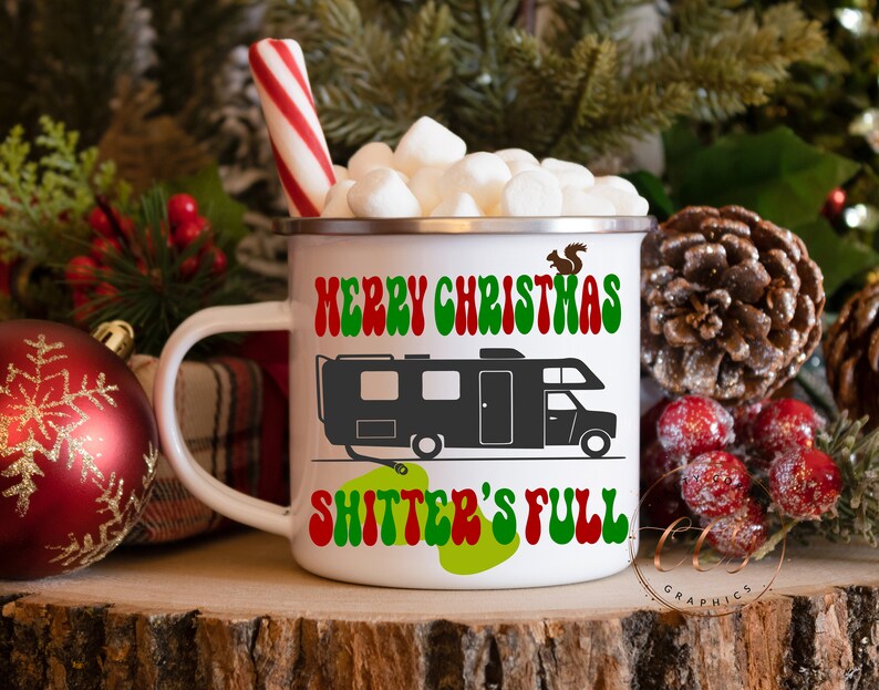 May include: White ceramic mug with a red and green "Merry Christmas" design and a black silhouette of a camper with the text "Shitter's Full" in green and red. The mug is filled with marshmallows and a red and white candy cane.